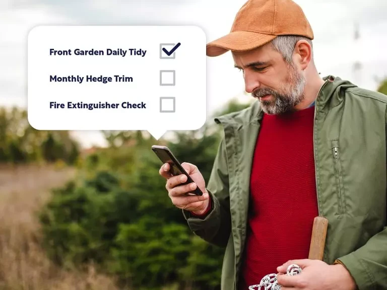 Hospitality staff member checking his task list on mobile device using Newbook software